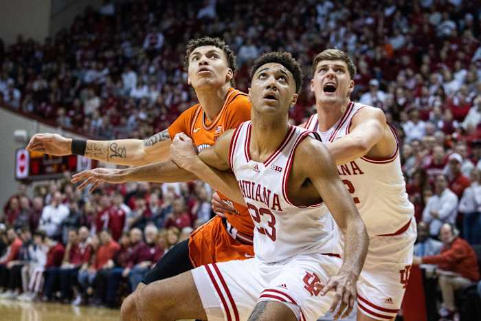 Indiana Hoosiers forward Trayce Jackson-Davis (23) and forward Miller Kopp (12) box out Illinois Fighting Illini forward Coleman Hawkins (33).